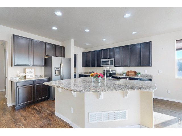 Property Photo 5 Huge island kitchen with 5 distinct granite counters, wood floors