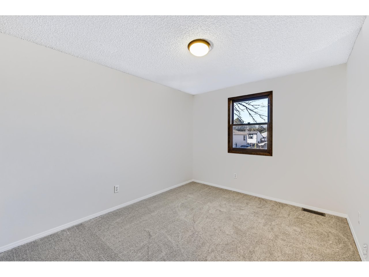 Property Photo 25 Spacious bedroom 2. New carpet and paint. Mountain views!