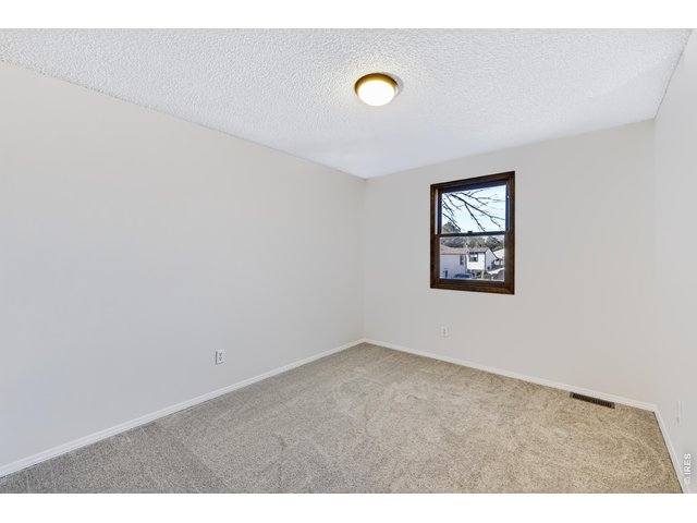 Property Photo 25 Spacious bedroom 2. New carpet and paint. Mountain views!