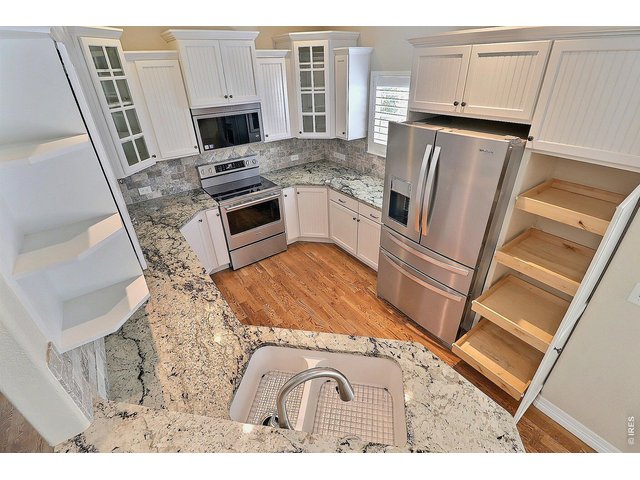 Property Photo 10 Kitchen Features a Pantry with Roll-Outs