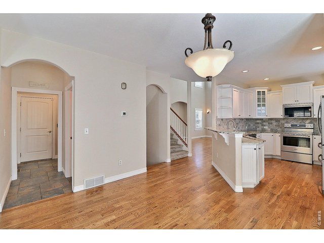 Property Photo 16 Wood Flooring Flows from Living Room Into Kitchen and Dining Room