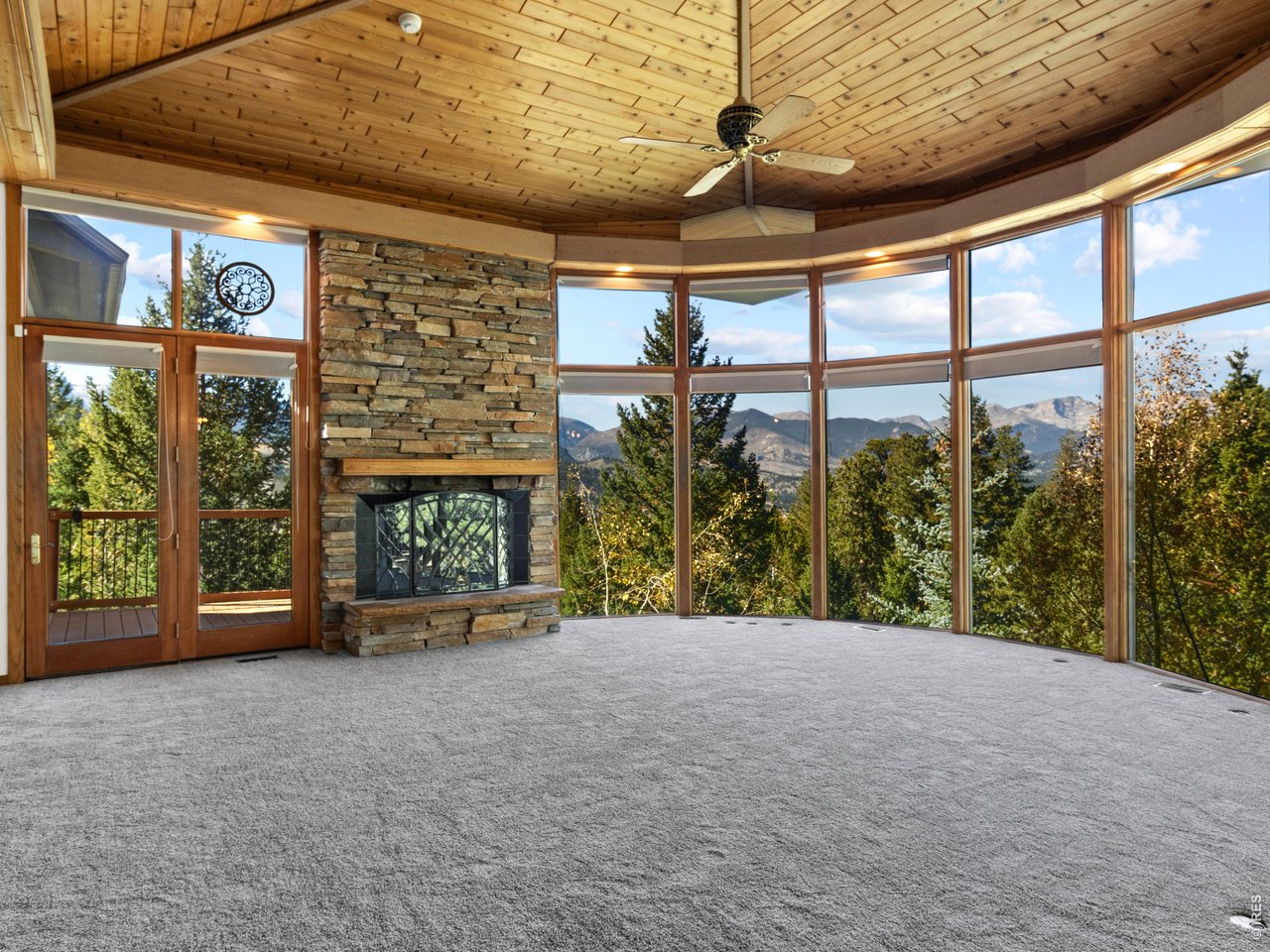 Property Photo 3 Living room features a tongue-in-groove ceiling, floor to ceiling windows, and a gorgeous view of the Continental Divide.