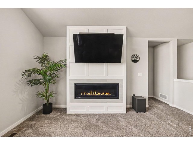 Property Photo 4 Living room has an electric fireplace with a beautiful accent wall