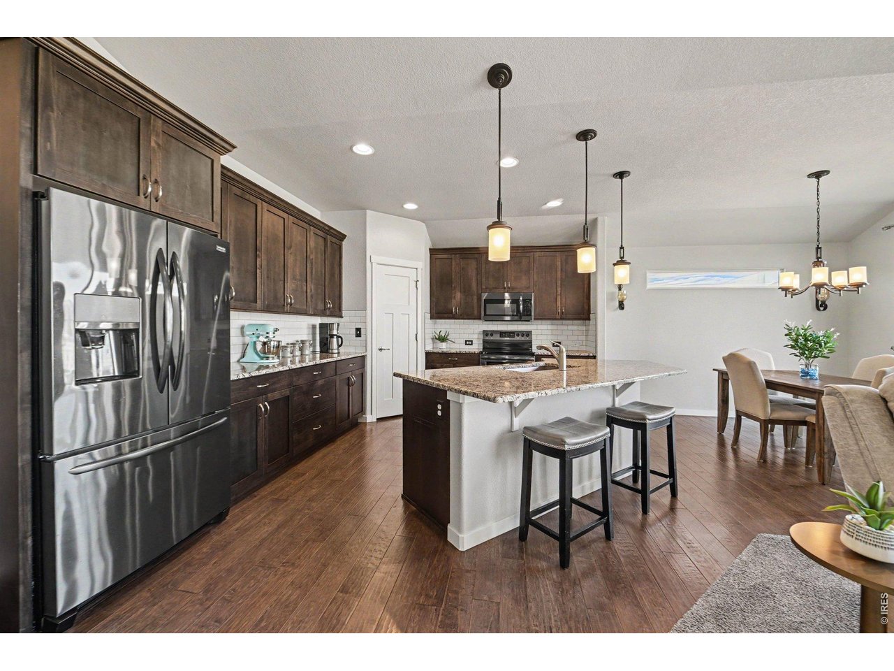 Property Photo 8 Spacious kitchen with stainless steel appliances and island with additional seating for guests!