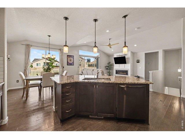 Property Photo 9 Granite counter tops and rich cabinets compliment the composite wood flooring.