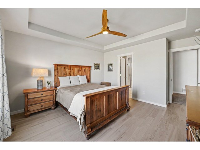 Property Photo 10 Primary bedroom with coffered ceiling and trendy ceiling fan.