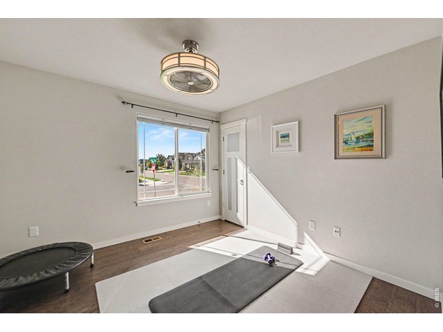 Property Photo 15 Bedroom #3 currently the exercise room with fandelier