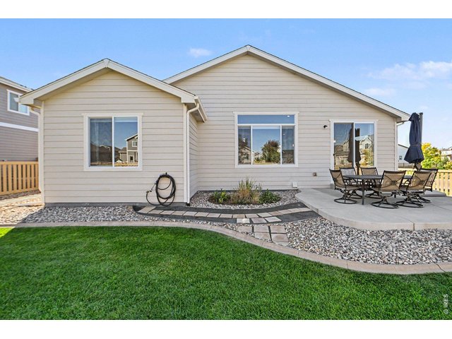 Property Photo 19 Backyard is beautifully landscaped with an oversized patio for additional entertaining under the Rocky Mountain skies.
