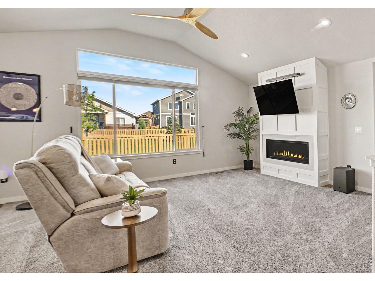 Property Photo 3 Spacious living area, natural light and freshly painted fireplace wall.