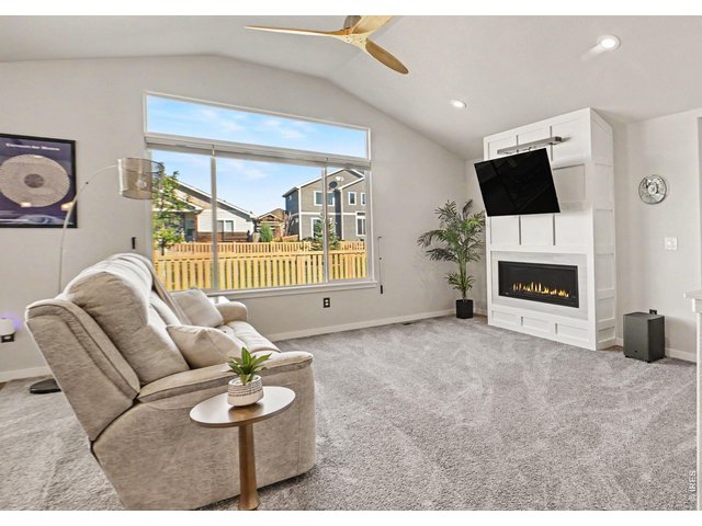 Property Photo 3 Spacious living area, natural light and freshly painted fireplace wall.