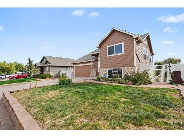 Property Photo 3 Angled Front View with Fenced Side Yard.