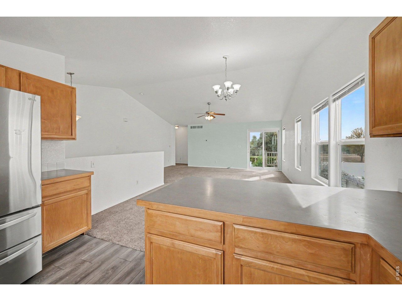 Property Photo 11 Modern kitchen featuring an expansive countertop, abundant natural light, and an open-concept layout that flows seamlessly into the living area.