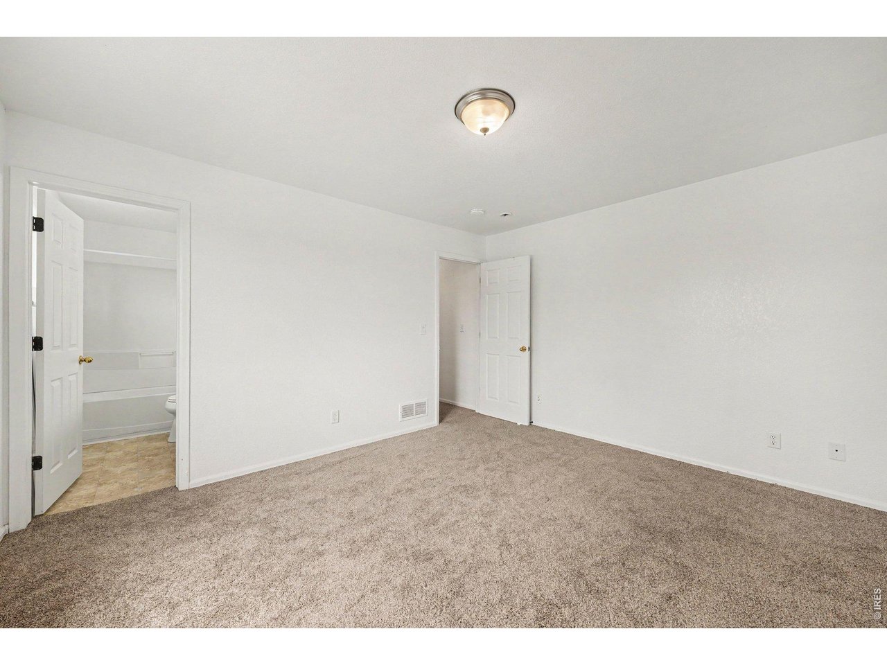 Property Photo 14 Primary Bedroom view showing spacious layout and natural lighting. Primary Bath