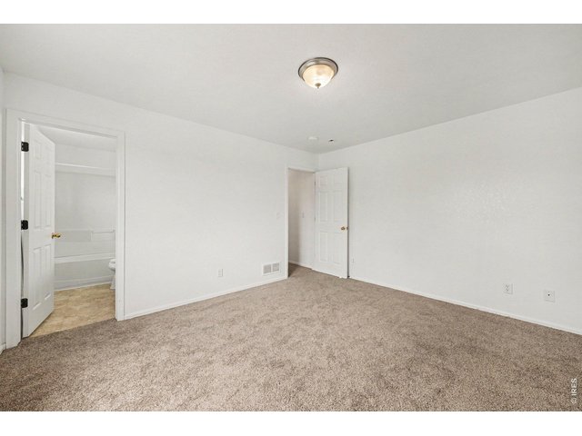 Property Photo 14 Primary Bedroom view showing spacious layout and natural lighting. Primary Bath