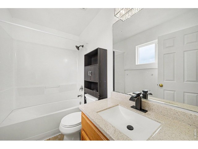 Property Photo 15 Primary Bathroom: Spacious shower and soaking tub combination.