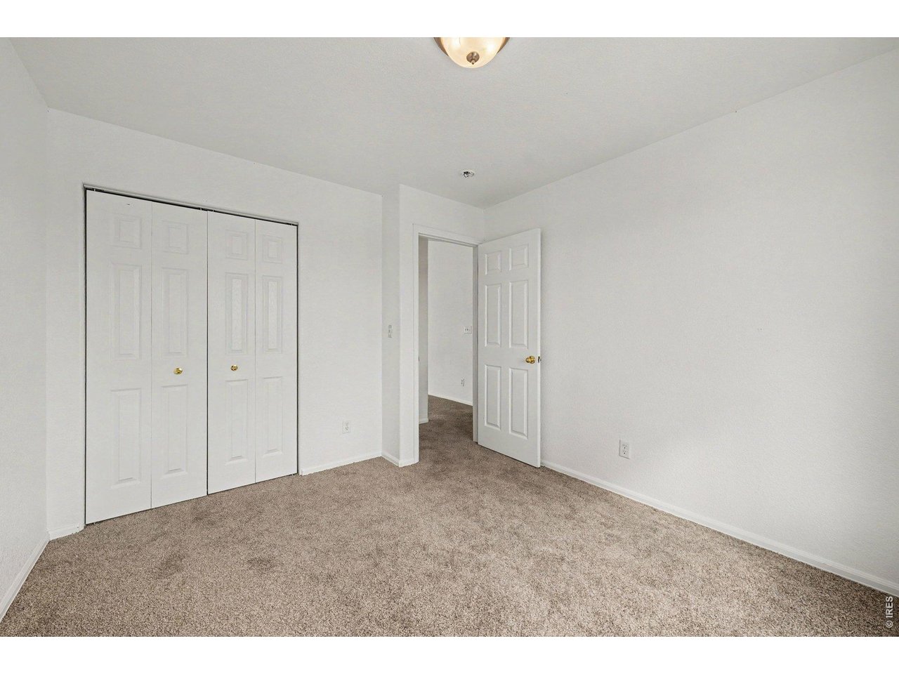 Property Photo 16 Large Guest Bedroom, Double-Door Closet, Neutral Carpet
