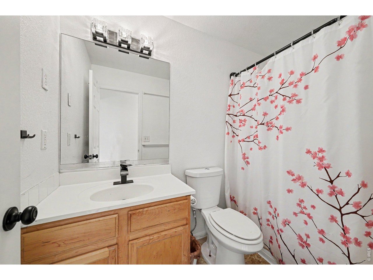 Property Photo 18 Guest bathroom located in the hallway featuring modern fixtures and finishes.