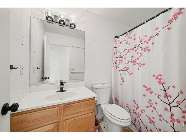Property Photo 18 Guest bathroom located in the hallway featuring modern fixtures and finishes.