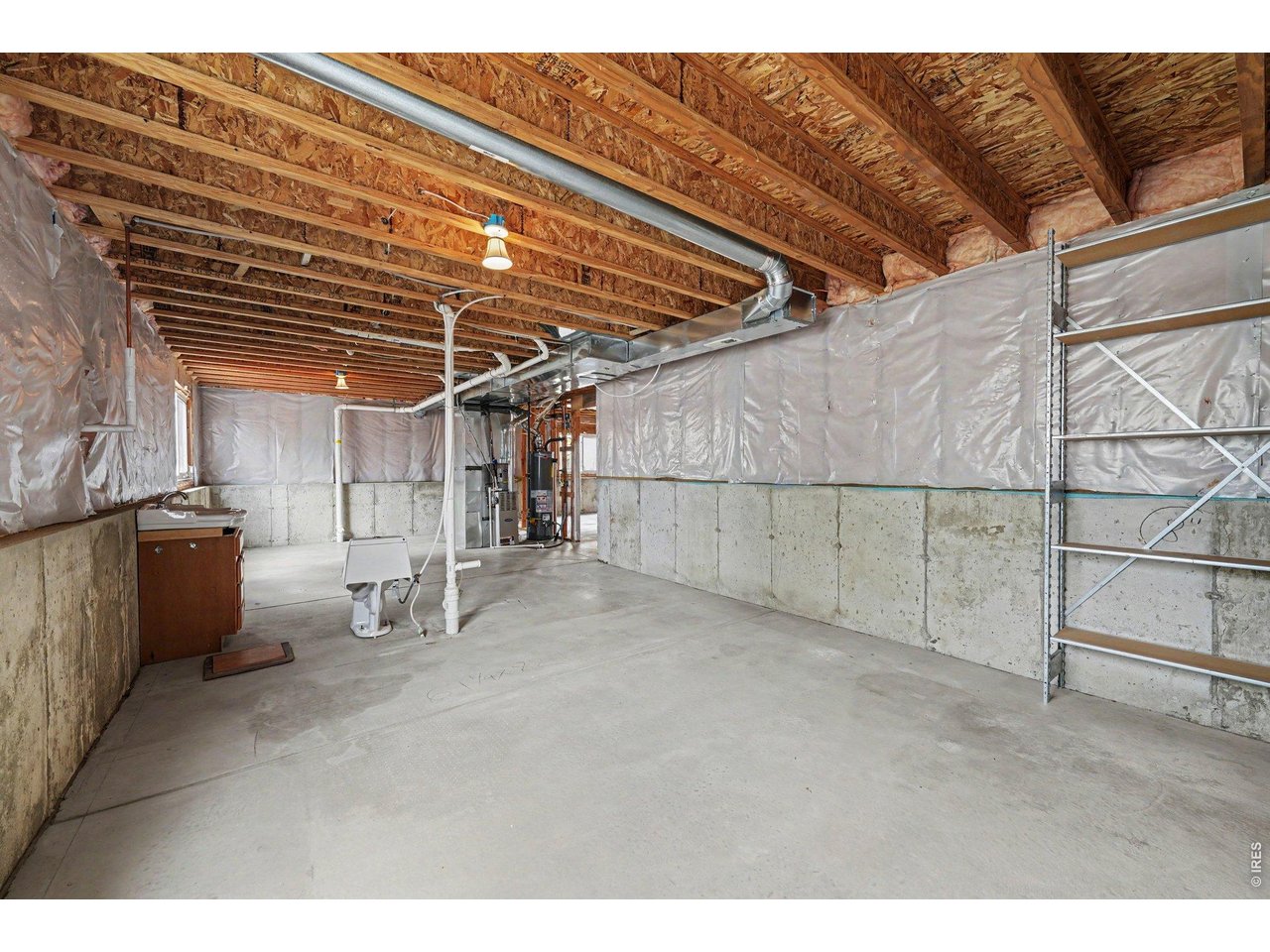 Property Photo 20 Basement with Rough-in Plumbing, Utilities and Storage Space