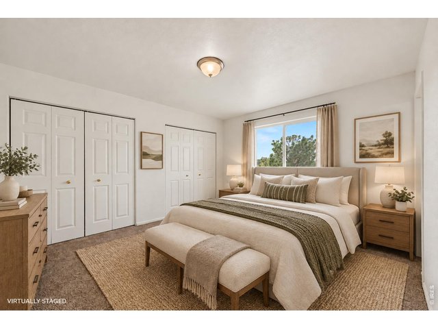 Property Photo 13 Virtually staged Primary Bedroom view showing spacious layout and natural lighting.