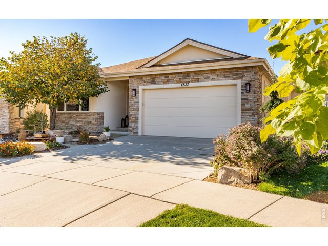 Property Photo 4 Welcome, beautiful flagstone entry and comfortable covered front porch and a beautiful RedBud tree to greet you!  Low Maintenance Stone and Stucco exterior.  Idyllic for the Colorado Outdoor Enthusiast!  Triple Glaze Andersen Windows!