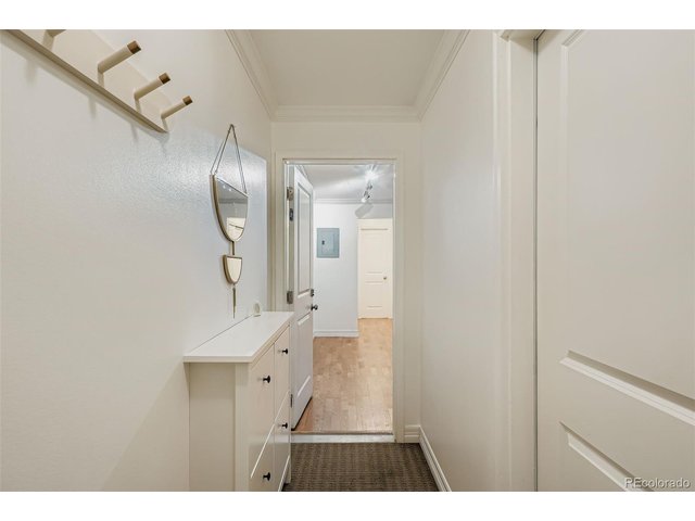 Property Photo 7 Hallway into unit, with laundry room on the right.