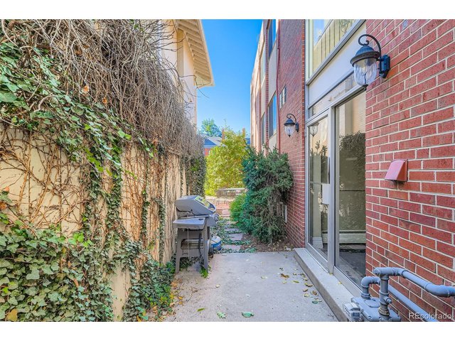 Property Photo 30 Garden spot with a BBQ grill with patio and chairs.