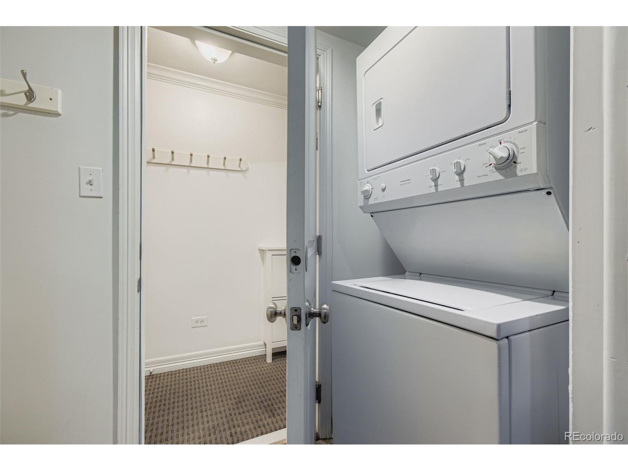 Laundry room with storage directly across from it.