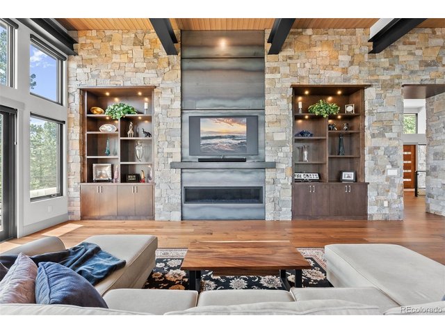 Property Photo 4 The expansive great room captivates with its impressive 20-foot wood ceilings