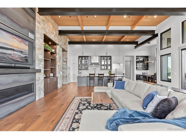 Property Photo 5 An open great room anchored by a beautiful fireplace creates a warm, welcoming space