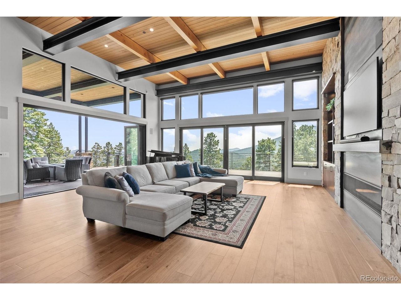 Large windows and La Cantina style sliding door that opens to the spacious deck, showcase breathtaking mountain views