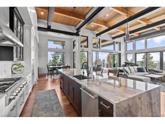 Property Photo 16 This culinary haven seamlessly connects to the dining area, great room and outdoor living areas, perfect for entertaining