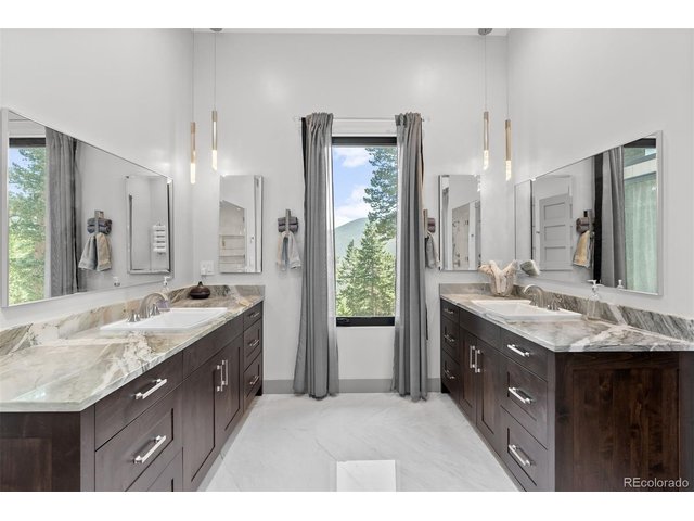 Property Photo 25 The luxurious main floor primary suite features a spa-like en-suite bathroom