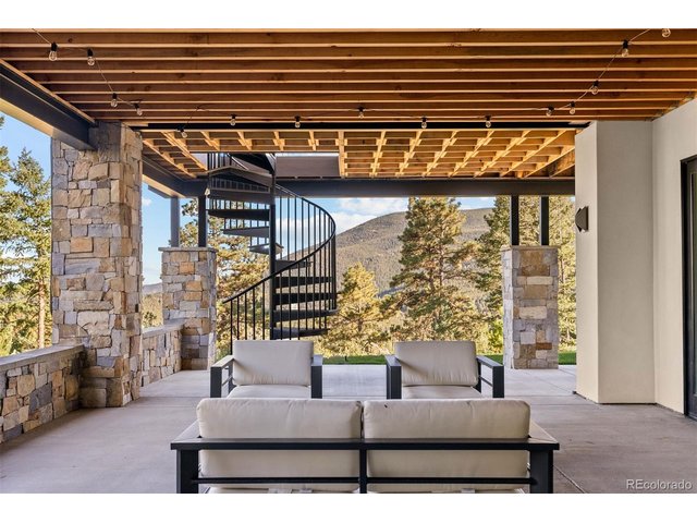 Property Photo 44 This outdoor patio is a stunning extension of the home, designed for relaxation and entertainment while embracing the natural surroundings