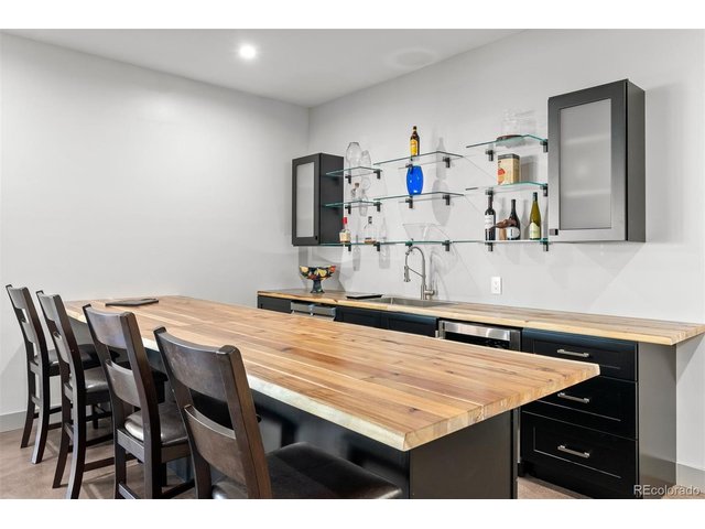 Property Photo 46 An oversized 12-foot bar topped with a stunning live edge butcher block