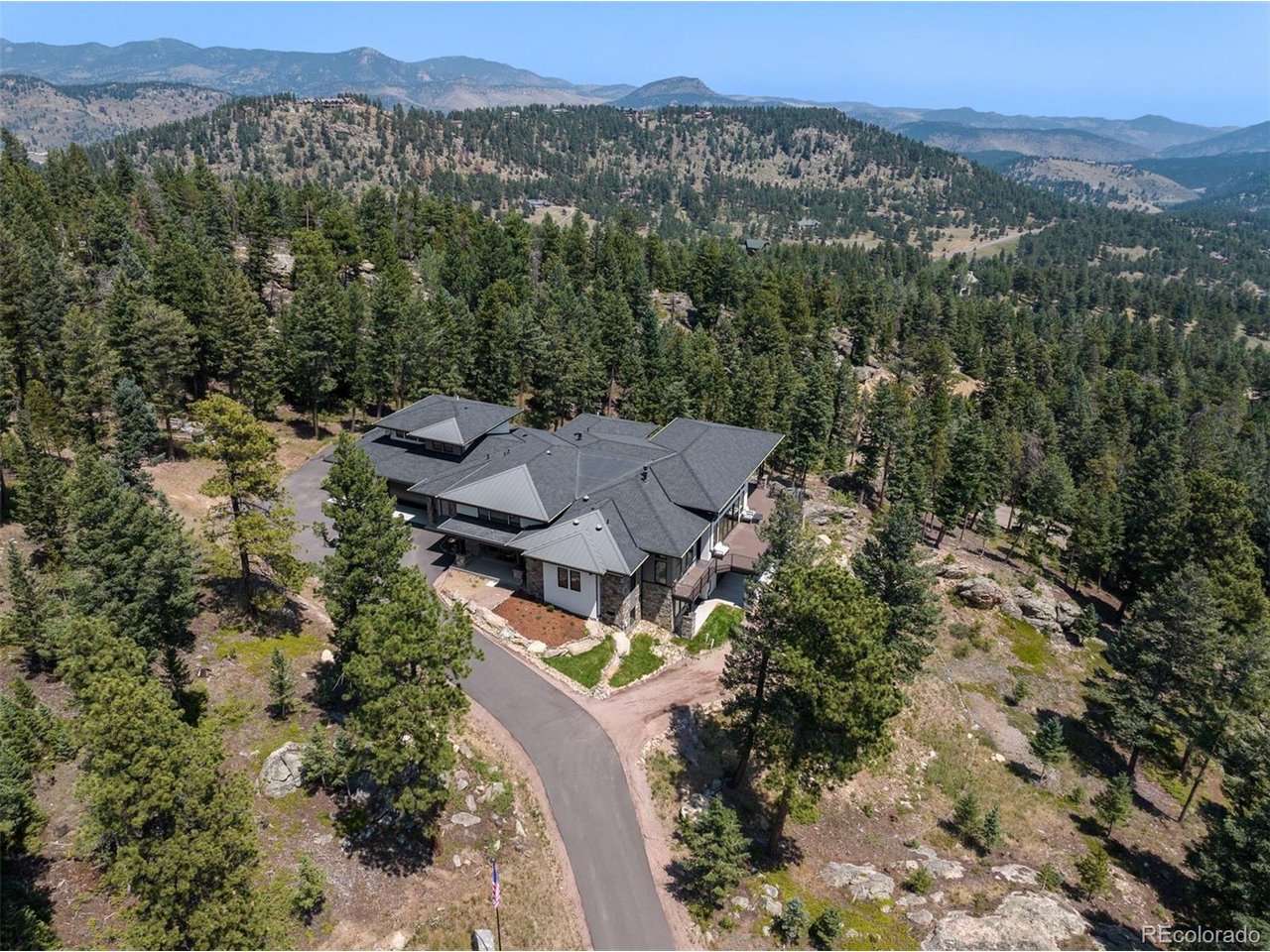 Nestled in a secluded setting, the home is surrounded by forest, providing privacy and a tranquil natural backdrop