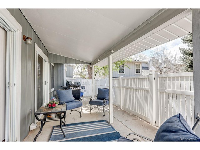 Property Photo 17 Covered and fenced back patio with extended area for BBQ