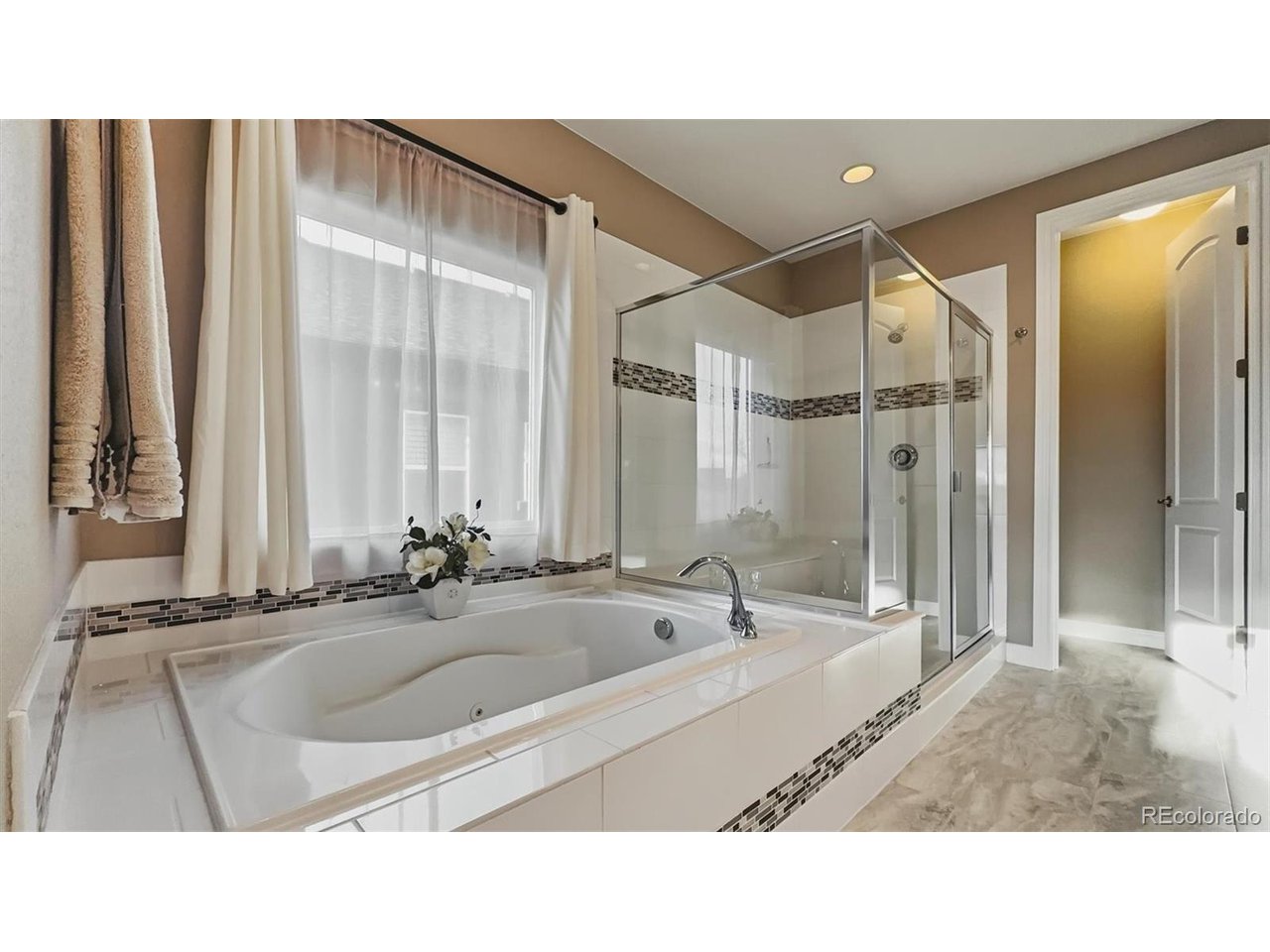 5pc Primary Bathroom with jetted tub, separate tiled shower, and dual sink vanity.