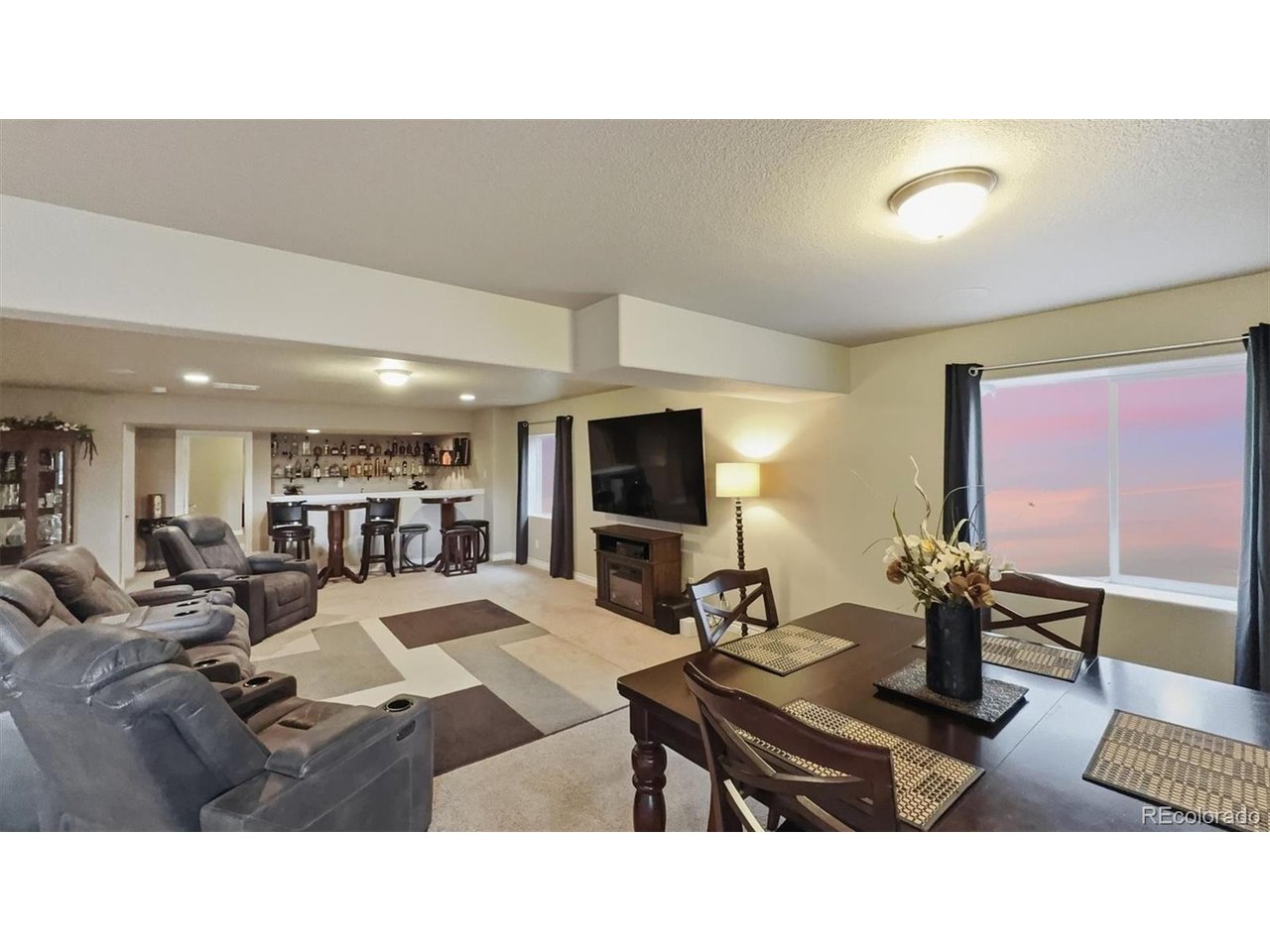 Spacious Basement Family/Rec Room with wet bar, TV area, and dining area.