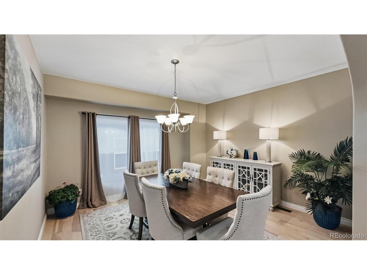 The Formal Dining Room features hardwood floors, and attractive light fixture, and large window that brings in natural sunlight.