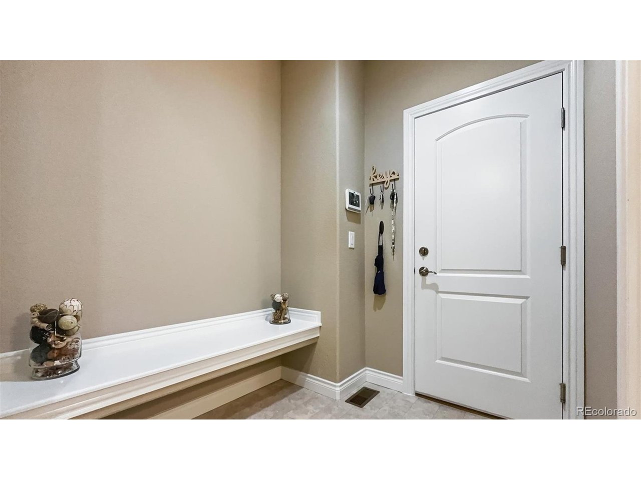 Mud Room with bench seat and garage access.
