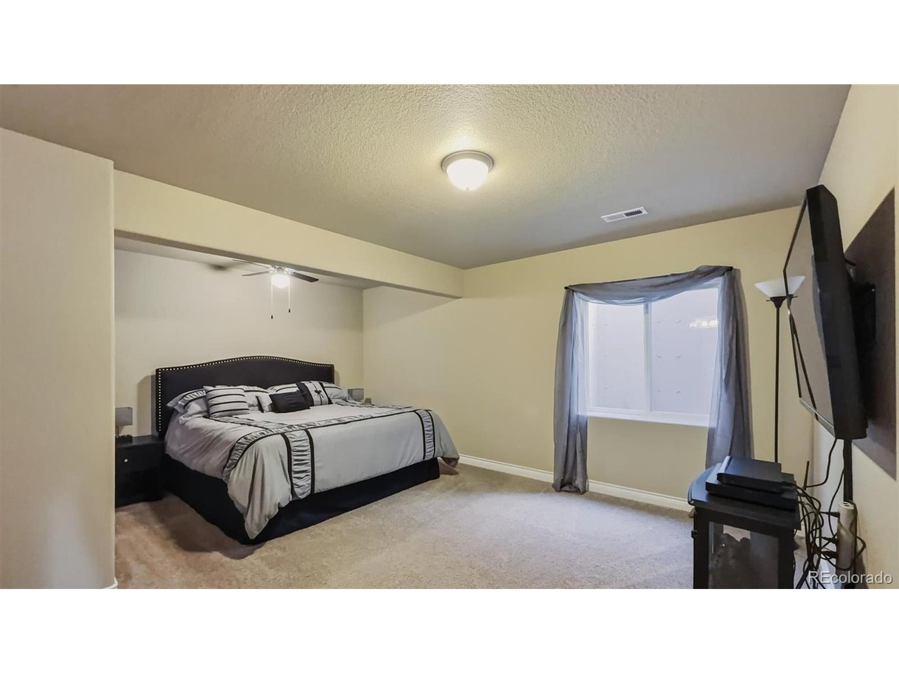 Basement Bedroom Suite #3 with neutral carpet, walk in closet, and adjoining Full Bathroom.