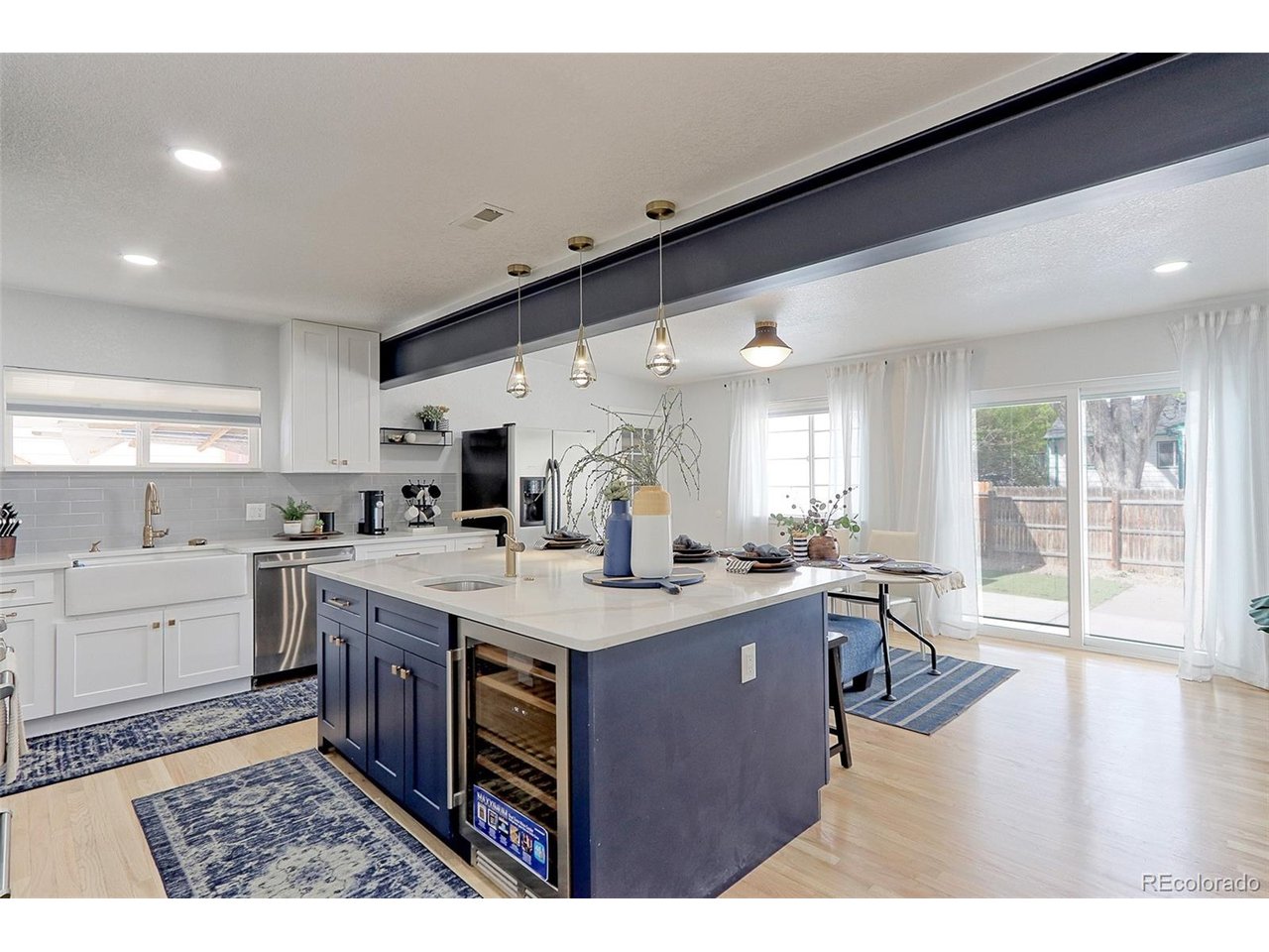 This kitchen features tons of custom shaker cabinets with designer pulls, solid Oak floors, solid marble counter tops, designer subway tile backsplash and built-in farmhouse sink