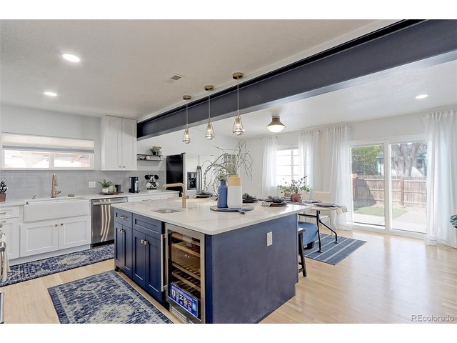 Property Photo 7 This kitchen features tons of custom shaker cabinets with designer pulls, solid Oak floors, solid marble counter tops, designer subway tile backsplash and built-in farmhouse sink