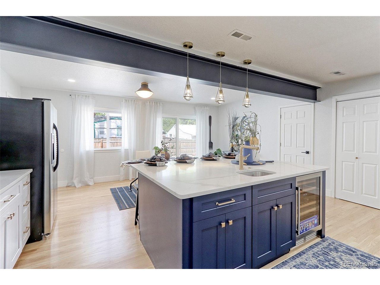 Check out the huge center prep and breakfast island with integrated prep sink, custom pendants and wine cooler.