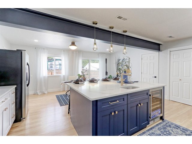 Property Photo 9 Check out the huge center prep and breakfast island with integrated prep sink, custom pendants and wine cooler.
