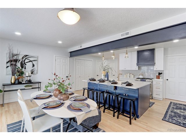 Property Photo 10 This large 17x9 eat-in dining room with solid oak floors features a designer overhead light fixture. There is plenty of room here for a table that seats 12.