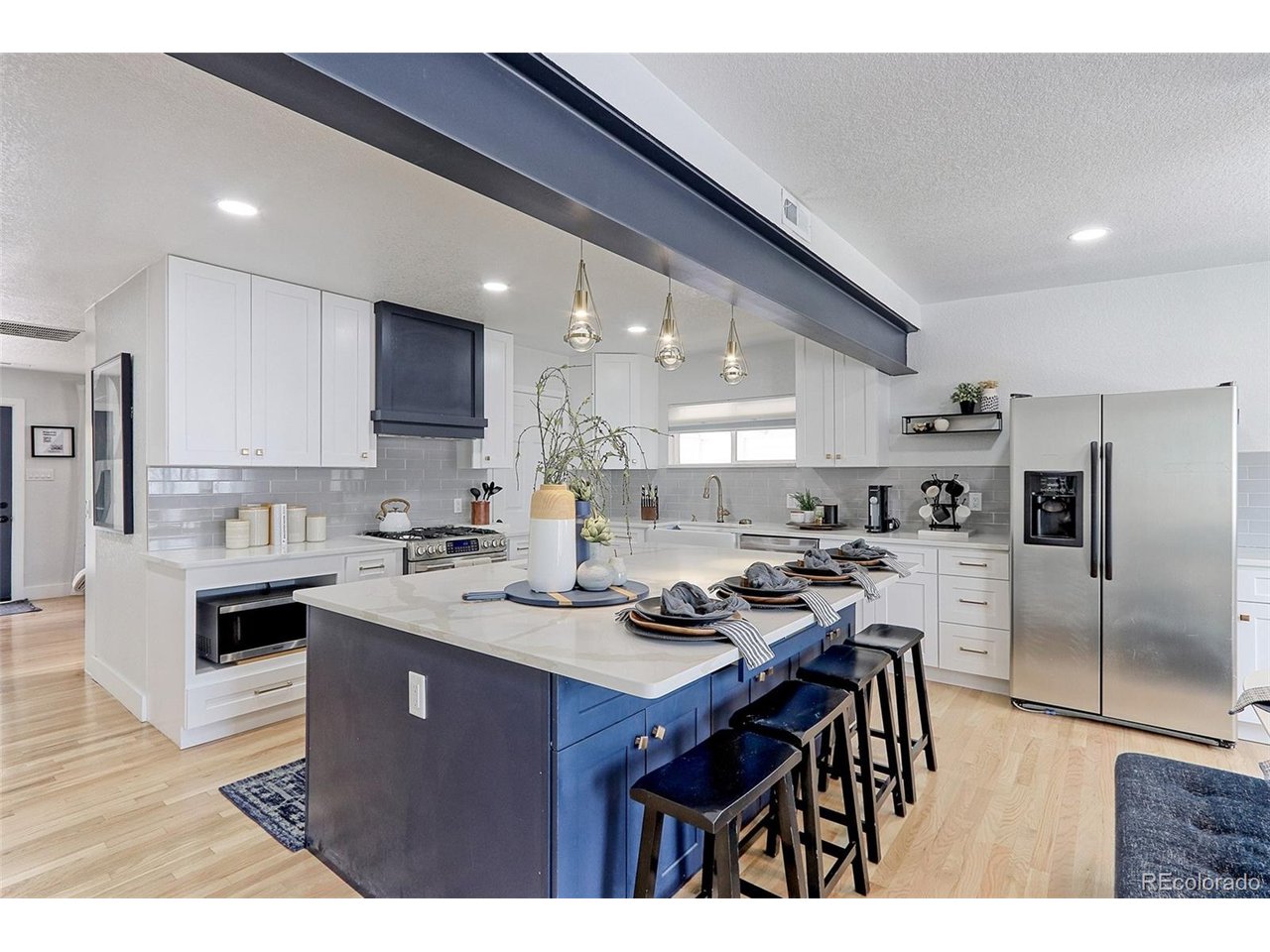 The kitchen comes complete with upgraded stainless appliances that include a side-by-side fridge with water and ice, microwave oven, dishwasher and gas range with custom lighted and vented hood.