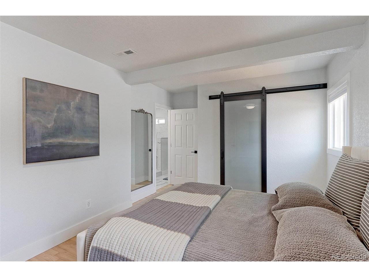 This suite has a large 7x7 walk-in closet with cool sliding glass barn door, plus a door to the private 5-piece bath.