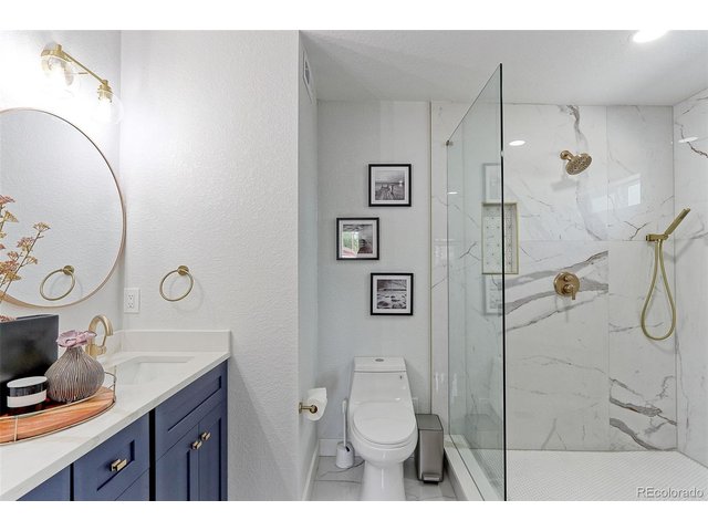 Property Photo 14 This private executive primary bath is incredible and features oversized marble tile floors, a custom dual vanity with solid Marble counter and integrated sinks, custom fixtures and treatments including a low flow elongated toilet.